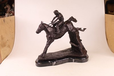 Lot 47 - A large modern bronzed figure of a racehorse...
