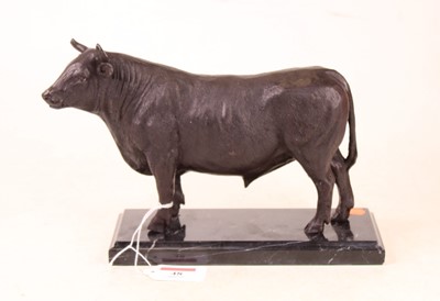 Lot 48 - A modern bronzed figure of a bull,...