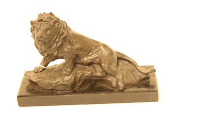 Lot 89 - A modern bronze figure of a recumbent lion, on...