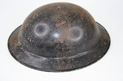 Lot 101 - A World War II steel Brodie helmet, having...