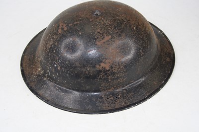 Lot 101 - A World War II steel Brodie helmet, having...