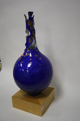 Lot 144 - An extremely large bottle vase, on a blue...