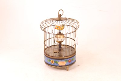 Lot 222 - A reproduction singing bird in cage clock...