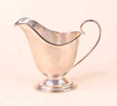 Lot 252 - A George V silver cream jug, of helmet shape,...