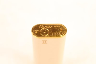 Lot 300 - A Cartier pocket cigarette lighter, the cream...