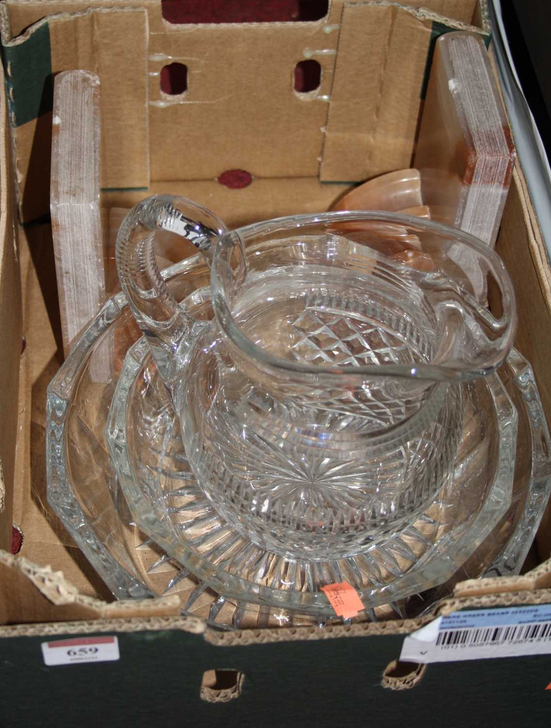 Lot 659 - A box containing a diamond cut glass water jug,...