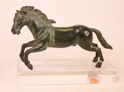 Lot 345 - A bronzed model of a galloping horse, on...