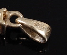 Lot 2304 - An 18ct yellow gold diamond set cross pendant,...