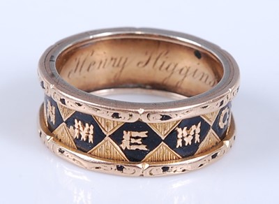 Lot 2306 - An 18ct yellow gold memorial ring, with In...