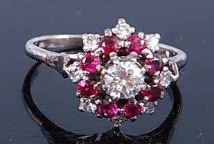 Lot 2310 - A white metal, ruby and diamond circular...