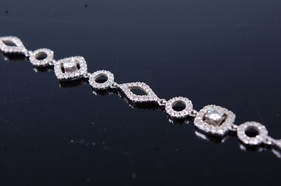 Lot 2340 - An 18ct white gold diamond fancylink bracelet,...
