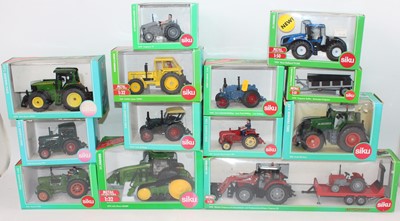 Lot 1528 - 13 various boxed Siku 1/32nd scale tractors...