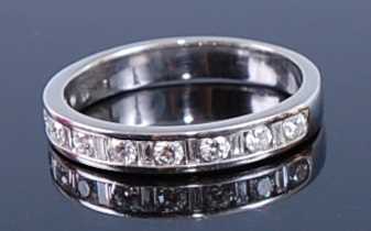 Lot 2346 - A white metal diamond half hoop eternity ring,...