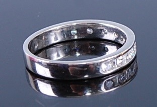 Lot 2346 - A white metal diamond half hoop eternity ring,...