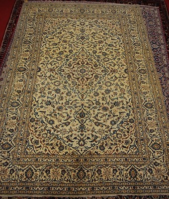 Lot 2590 - A Persian woollen Kashan carpet, the cream...