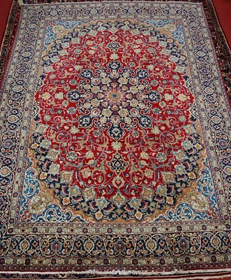 Lot 2591 - A Persian woollen Isfahan carpet, the red...