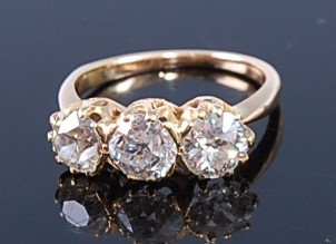 Lot 2356 - A yellow metal diamond three stone ring,...