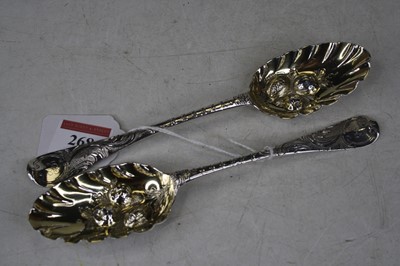 Lot 2080 - A near-pair of George II silver berry spoons,...