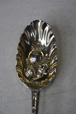 Lot 268 - A near-pair of George II silver berry spoons,...