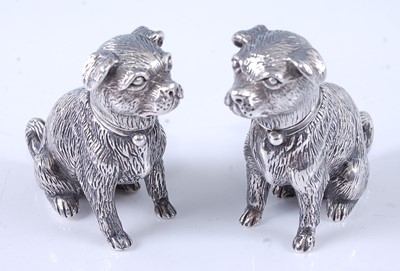 Lot 2073 - A pair of cast silver novelty pepperettes,...