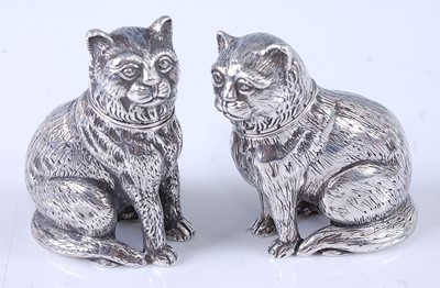 Lot 2074 - A pair of cast silver novelty pepperettes,...