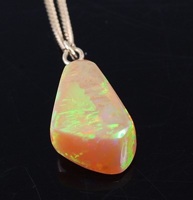 Lot 328 - A polished opal pendant, of irregular...