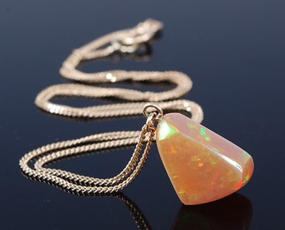 Lot 2361 - A polished opal pendant, of irregular...
