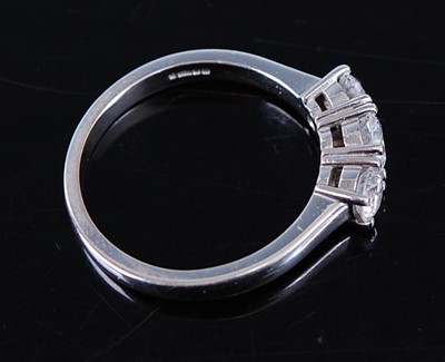 Lot 2364 - A platinum diamond 'trilogy' ring, arranged as...