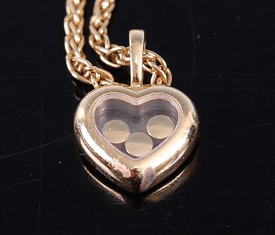Lot 2372 - A Chopard 18ct gold 'Happy Diamonds' heart...