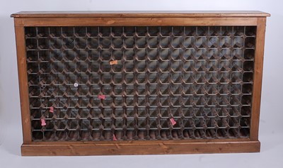 Lot 1543 - A contemporary pine wine rack, raised upon a...