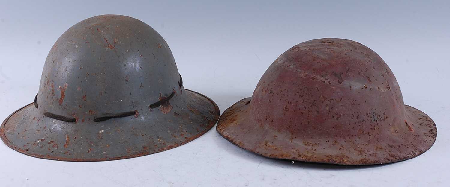 Lot 122 - A WW II Zuckerman steel helmet, in green...