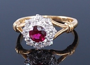 Lot 2374 - An 18ct gold, ruby and diamond flower head...