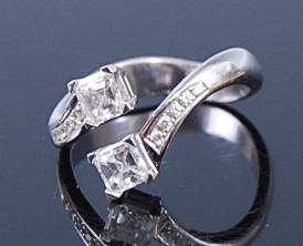 Lot 2373 - An 18ct white gold diamond crossover ring,...