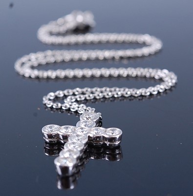 Lot 2363 - An Asprey platinum diamond cross pendant, on...