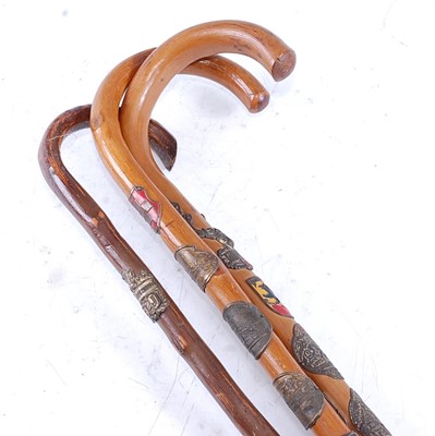 Lot 295 - A collection of three Swiss walking sticks,...
