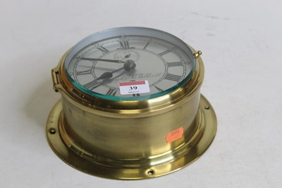 Lot 39 - A brass cased ships clock, the circular...