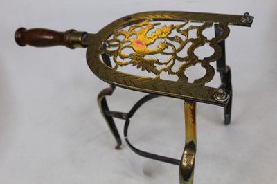 Lot 50 - A 19th century brass trivet, of lyre shape,...
