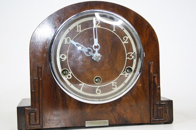 Lot 156 - A 1930s walnut cased mantel clock having...