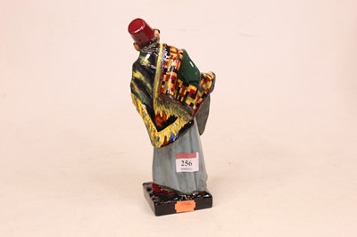 Lot 256 - A Royal Doulton figure of a carpet seller,...