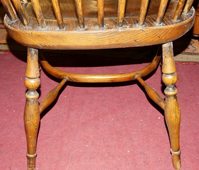 Lot 1402 - An elm and oak comb back Windsor chair, with...