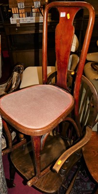 Lot 1417 - An elm and beech wheelback elbow chair;...
