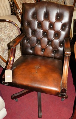 Lot 1424 - A mahogany tan leather buttoned and studded...