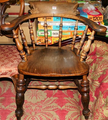 Lot 1451 - A circa 1900 elm captain's chair, width 64cm