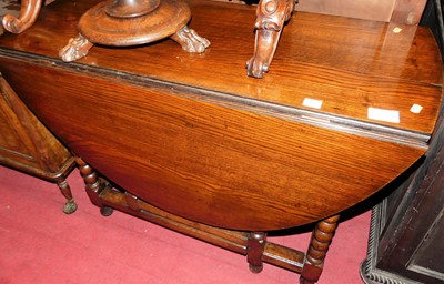 Lot 1479 - A 19th century joined oak drop leaf dining...