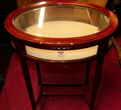 Lot 1480 - A stained beech oval bevelled glazed top...