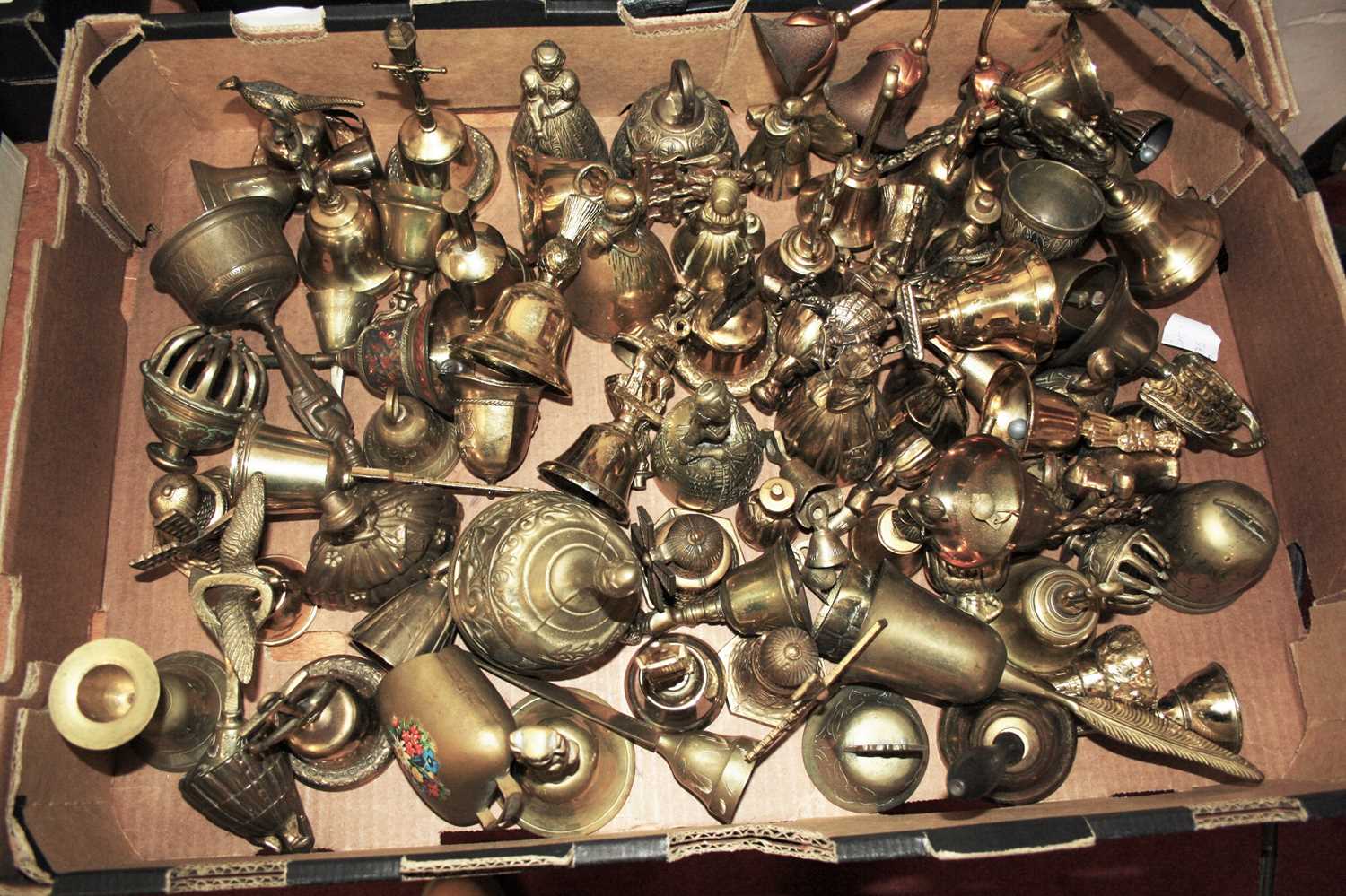 Lot 784 - A box of ornamental brass hand bells, to...