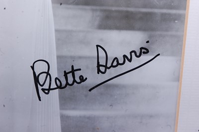Lot 1129 - Bette Davis, (1908-1989), a black and white...
