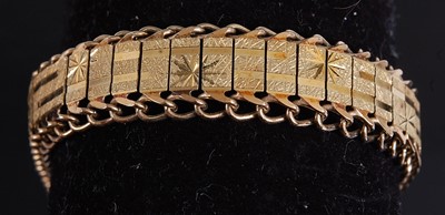 Lot 2170 - A yellow metal bracelet, having a central...