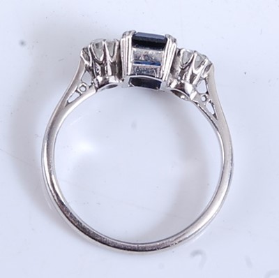 Lot 2165 - A white metal, sapphire and diamond three...