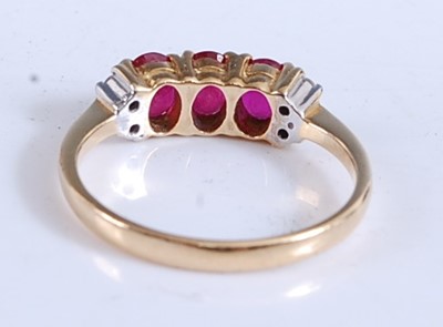 Lot 2166 - A yellow metal, ruby and diamond dress ring,...